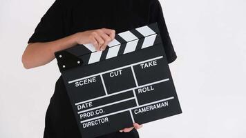 Child claps a movie slate in slow motion against a clean white background video