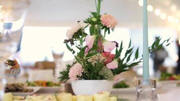 A beautifully set buffet table decorated with elegant flowers at a reception. video