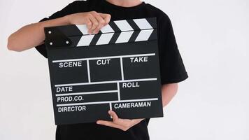 Clapping clapper on white background by boy in black t-shirt video