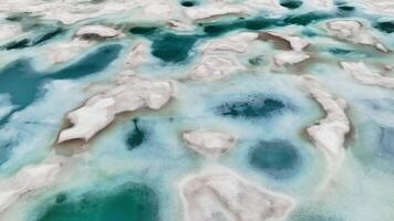 Lake with snow covered Swiss Alps in the background. Mountain lake where an avalanche has occurred. Drone flight over the lake, abstract snow background video