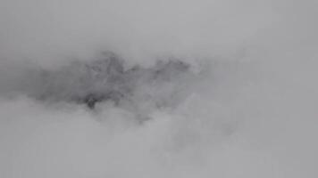 footage. Picturesque aerial view from airplane window on white cloud moving inside. Abstract smoke cloud, fast movement, clouds moving forward towards camera, drone flight from below video