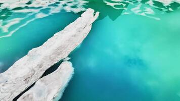 Beautiful alpine lake in the mountains, landscape. Aerial flight over the lake in summer. Melting glaciers video