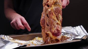 Fresh pork steak, marinated meat prepared for baking with garlic. Place on foil in a baking dish video