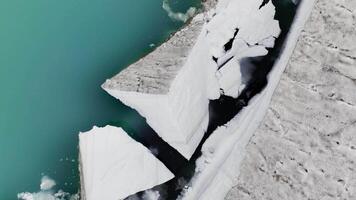 Icebergs from a melting glacier in a lagoon in Iceland, Arctic icy landscape in a UNESCO World Heritage Site, aerial view from a drone. Climate change and global warming video