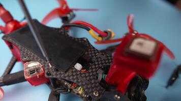Close up of a hand screwdriver male craftsman unscrewing a fpv self-assembled drone on his desk. Shallow depth of field. Unscrewing and screwing video