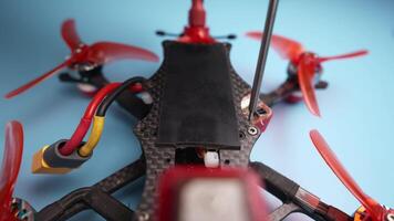Close up of a hand screwdriver male craftsman unscrewing a fpv self-assembled drone on his desk. Shallow depth of field. Unscrewing and screwing video