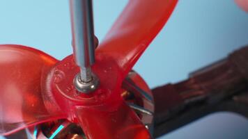 Close-up macro of screwing in propeller mounting screws on a DIY drone's brushless motor video