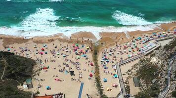 From above view of anonymous people on sandy seashore at Magoito Beach video