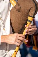 Detail of the hands of a man playing the typical Galician bagpipe. Folk music concept photo