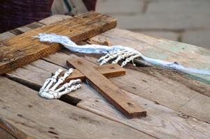 hands of a skeleton coming out of a coffin lid, halloween decorations photo