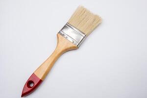 View of a painter's brush with wooden handle on a white background photo