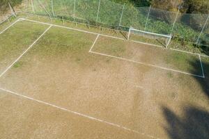 Aerial view of the area and the goal of a dirt soccer ground. photo
