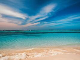 A beach with waves and a blue sky photo