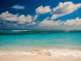 A sandy beach with blue water and white clouds photo