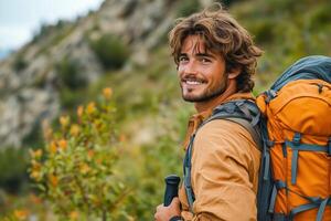 A man with a backpack smiles while hiking photo