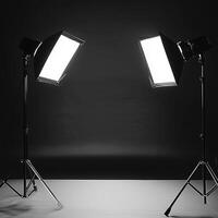 Professional photography studio with dual softbox lights and black background for high-contrast lighting setup photo