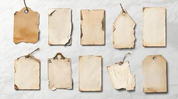 Set of vintage blank paper tags with distressed edges, rustic texture, and twine on light background photo