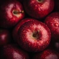 Close-up of fresh red apples with water droplets creating a rich texture and vibrant color photo
