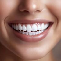 Close-up of a smiling woman with bright white teeth and smooth lips highlighting natural beauty photo