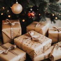 Beautifully wrapped Christmas gifts under the tree with sparkling ornaments and golden ribbons photo