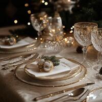 Elegant Christmas dinner table setting with gold accents, glassware, and festive decorations photo