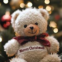 Fluffy white teddy bear with a red scarf and Merry Christmas message sitting in front of festive holiday lights photo