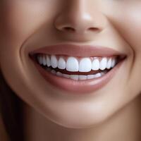 Close-up of a smiling woman showing white teeth and smooth lips with radiant and healthy skin photo