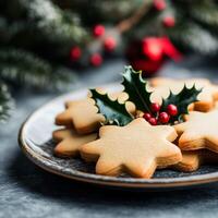 Festive Christmas cookies in star shapes decorated with holly on a plate surrounded by holiday greenery photo