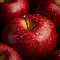 Close-up of a ripe red apple with water droplets creating a fresh and vibrant texture photo