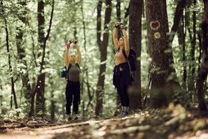 Mother And Daughter Enjoying Taking Deep Breath In The Forest photo