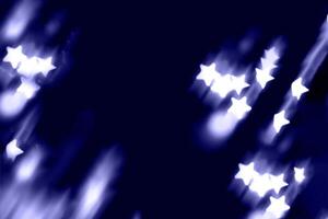 Blurry garland lights on a dark background. Festive Christmas and New Year background. Soft focus photo