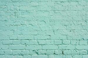 The brick wall is painted with green paint. Abstract construction design background. photo