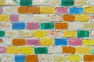 Wall made of multi-colored bricks. Abstract design background. photo
