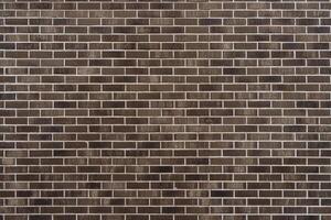 Brown brick wall. Abstract construction background. photo