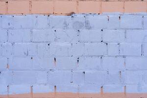 The old wall is unevenly painted. Abstract construction background. photo
