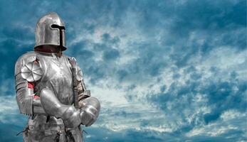 Knight in helmet and metal armor. photo
