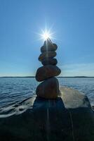 Pyramid of stones. Unstable balance of stone objects. Idyllic state of nature. photo