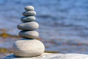 Pyramid of stones. Unstable balance of stone objects. Idyllic state of nature. photo