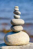 Pyramid of stones. Unstable balance of stone objects. Idyllic state of nature. photo