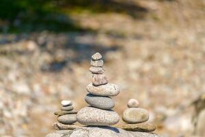 Pyramid of stones. Unstable balance of stone objects. Idyllic state of nature. photo