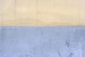 Half the plastered wall is white, half is blue. photo