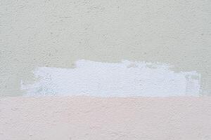 Traces of paint on old white plaster. Abstract construction background. photo