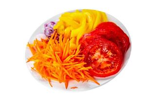salad fresh vegetables cut into a plate tomato, carrot, pepper, onion juicy fresh gourmet food background on the table rustic food top view copy space keto and paleo diet Vegetarian and vegan photo