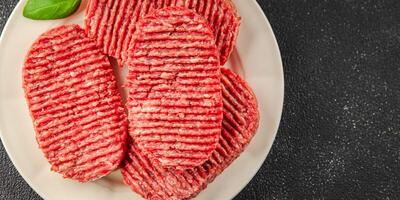 Raw cutlet fresh ground meat beef burger, pork, chicken, turkey second course dish fresh delicious gourmet food background on the table rustic food top view copy space photo