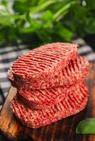Raw cutlet fresh ground meat beef burger, pork, chicken, turkey second course dish fresh delicious gourmet food background on the table rustic food top view copy space photo