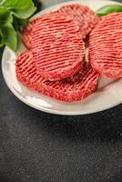 Raw cutlet fresh ground meat beef burger, pork, chicken, turkey second course dish fresh delicious gourmet food background on the table rustic food top view copy space photo
