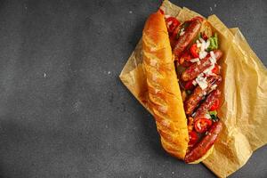 hot dog sausages, bun, greens, sauce fast food delicious food dish Fresh delicious gourmet food background on the table rustic food top view copy space photo
