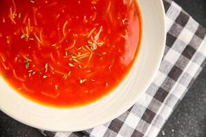 Tomato soup vermicelli gazpacho first course dish fresh gourmet food background on the table rustic food top view copy space photo