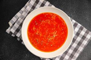Tomato soup vermicelli gazpacho first course dish fresh gourmet food background on the table rustic food top view copy space photo