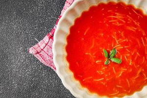 Tomato soup vermicelli gazpacho first course dish fresh gourmet food background on the table rustic food top view copy space photo
